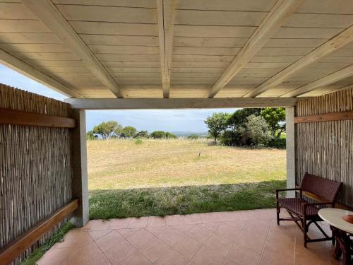 a screened porch with a view of a field at Agriturismo La Tegghja in Rena Majore