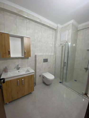 ein Badezimmer mit Waschbecken, Toilette und Dusche in der Unterkunft Kıvanç Residence in Trabzon