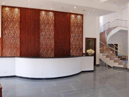 a lobby with a staircase in a building at Vai by Romance Hotel & Aqua Park in Ain Sokhna