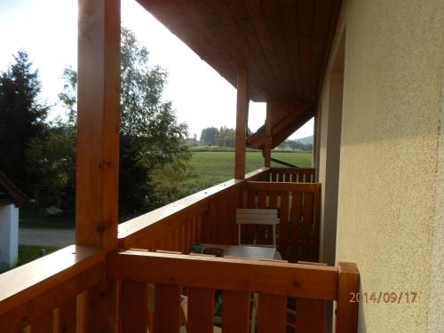 a screened in porch with a view of a field at Penzion Naděje in Benešov nad Černou