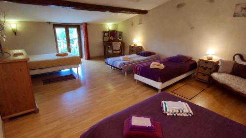 a living room with two beds and a couch at Gites PassionPastel in Pech-Luna
