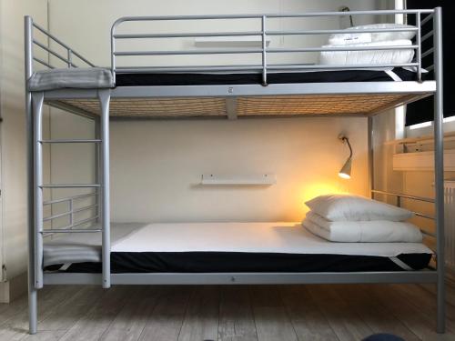 a bedroom with two bunk beds and a lamp at Örebro City Hostel in Örebro
