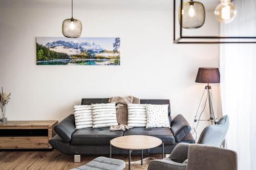 a living room with a couch and a table at Apartments Frauensee in Reutte