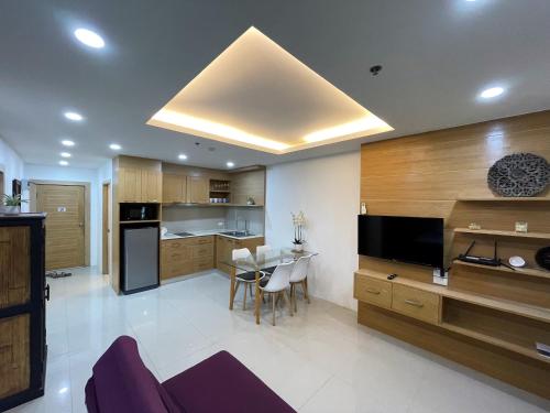 a living room with a kitchen with a dining table at Patong Tower apartment by Lofty in Patong Beach