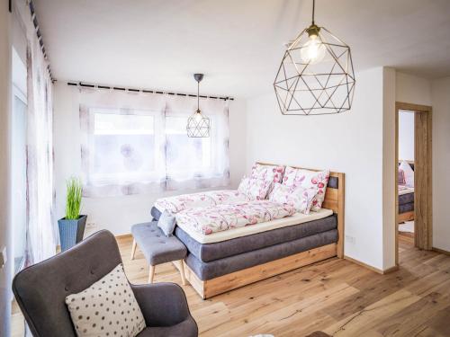 a living room with a couch and a chair at Apartments Frauensee in Reutte
