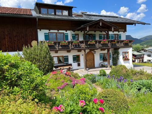 ein Haus mit einem Blumengarten davor in der Unterkunft Oberstöberl in Bischofswiesen