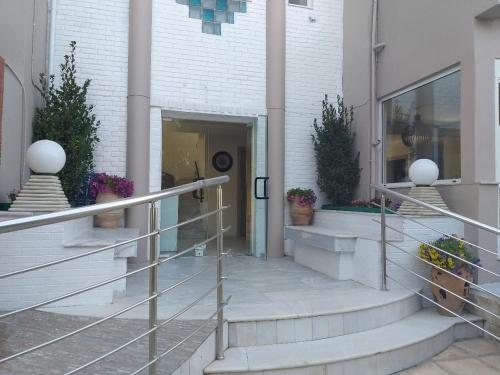 a hallway of a building with stairs and plants at Troulis Seaside in Amoudara Herakliou