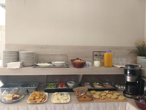 a kitchen with plates of food on a counter at Troulis Seaside in Amoudara Herakliou