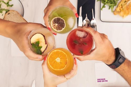 a group of people holding up different types of drinks at YOTEL Porto in Porto