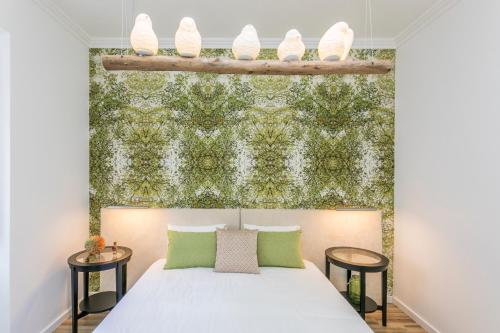 a bedroom with a bed with a green wall at São José by SpotOn Apartments in Lisbon