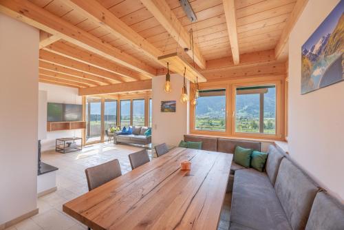 a living room with a wooden table and a couch at Chalet Oxygen in Fürth