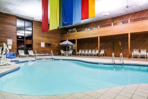 a large pool in a hotel with a rainbow flag at Days Inn & Suites by Wyndham Wausau in Wausau