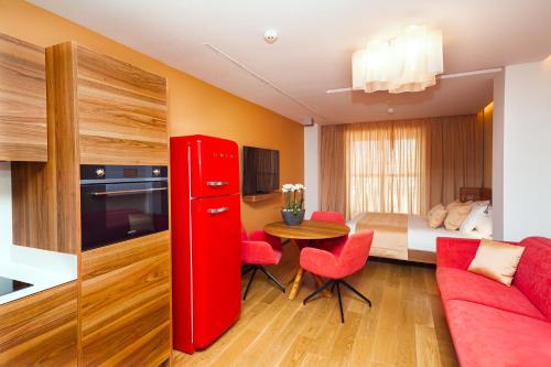 a red refrigerator in a room with a bedroom at Bohemia Suites & Spa - Adults Only in Playa del Ingles
