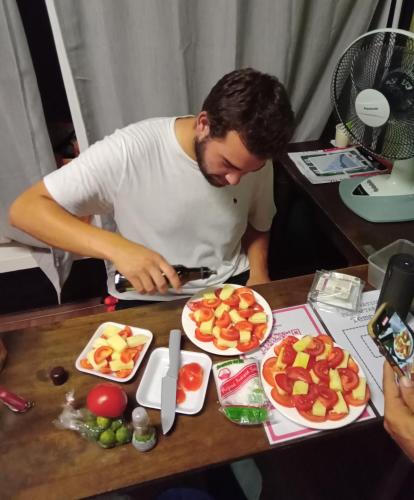 a man standing at a table with plates of food at TEMPO EXT. in Semporna