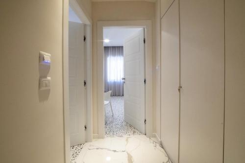 a hallway with a white door and a room at Neva Suites Massa Lubrense Sorrento Coast in Massa Lubrense