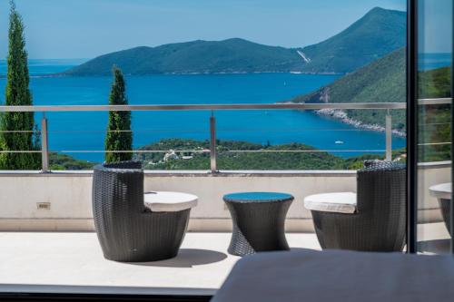 a balcony with a view of the water at Villa Lustica in Lustica