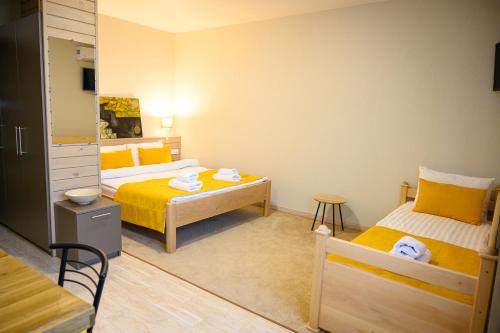 a small room with two beds and a table at Space Apart Hotel in Lutsk
