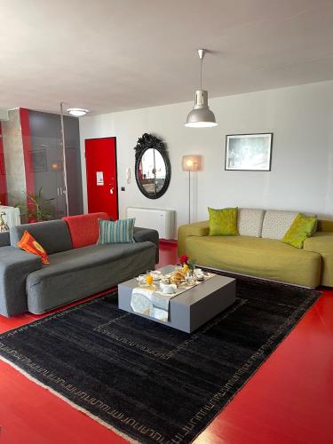a living room with two couches and a coffee table at Metro Suites in Tirana