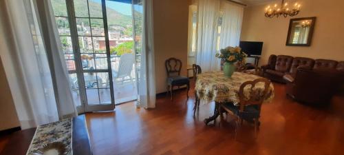 a living room with a table with a vase of flowers on it at Hotel Dora in Levanto