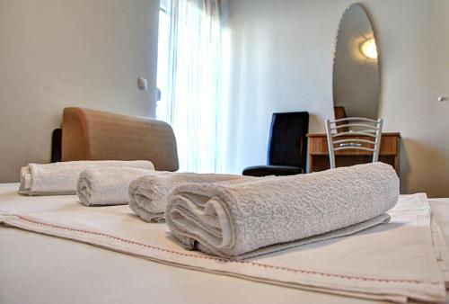 two towels sitting on top of a bed at Apartmani Obala in Promajna