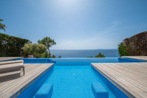 a pool with a view of the ocean from a villa at Herce Property - Minimalist & Mediterranean in Llucmajor