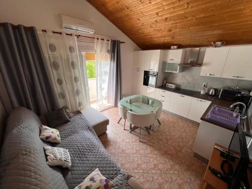 a living room with a couch and a table at Apartmani Premijer-Rab in Supetarska Draga