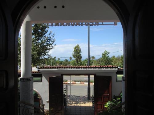 an archway leading into a building with a view of a courtyard at Pasta Plaza in Asilah