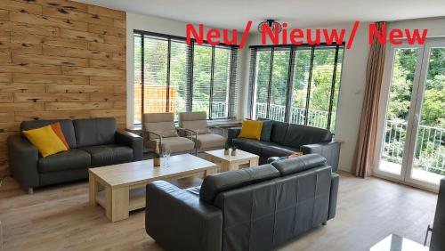 a living room with couches and a coffee table at Villa Bad Bertrich in Bad Bertrich