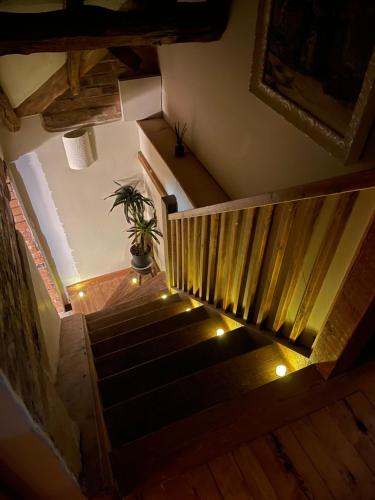 a stairway with a potted plant and lights at Elegant peaceful barn in rural village setting close to Stratford upon Avon in Stratford-upon-Avon