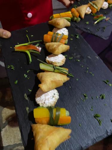 a black table with some food on it at Hôtel Restaurant Coco Lodge Majunga in Mahajanga