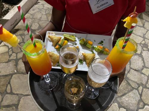 a tray of drinks and food on a table at Hôtel Restaurant Coco Lodge Majunga in Mahajanga