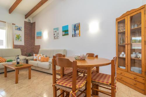 a living room with a table and a couch at Filippi in Son Parc