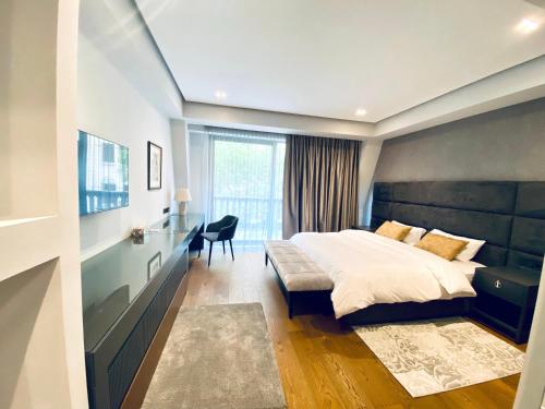 a bedroom with a large bed and a window at Heart of Yerevan - City Center Luxury Apartments in Yerevan