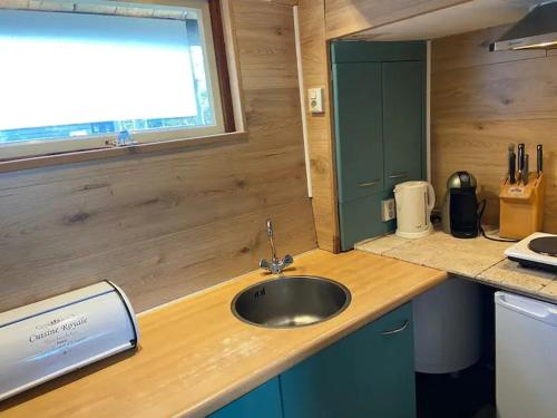 a kitchen counter with a sink and a window at Eikelhof in Berkel-Enschot