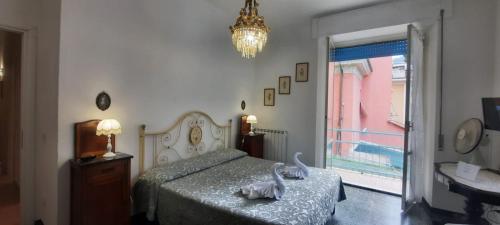 a bedroom with a bed and a chandelier at Hotel Dora in Levanto