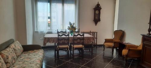 a living room with a table with chairs and a couch at Hotel Dora in Levanto