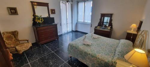 a room with a bed and a dresser and a mirror at Hotel Dora in Levanto