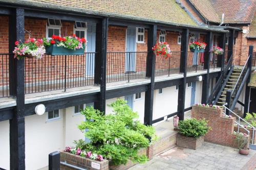 a row of houses with flower boxes on their balconies at Cottesmore Hotel Golf & Country Club in Crawley