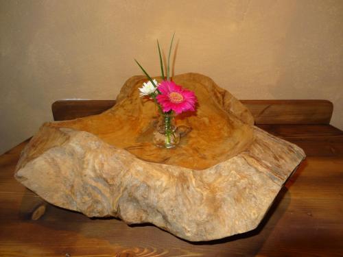 a vase of flowers sitting on top of a wooden table at Hotel Deutsches Haus Anno 1898 in Sonthofen