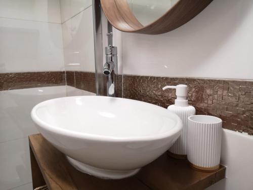 a bathroom with a white sink and a mirror at Lemon Tree House Coimbra - Courtyard garden with city views in Coimbra