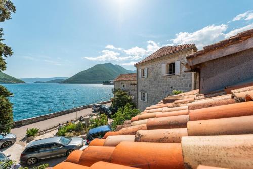 a view of the water from the roof of a building at Charming Bohemian house in Perast in Perast