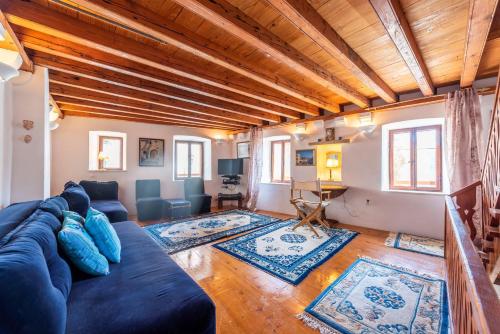 a living room with a blue couch in a room at Charming Bohemian house in Perast in Perast