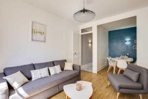 a living room with a couch and a table at GuestReady - Amazing Flat in Saint Michel in Lyon