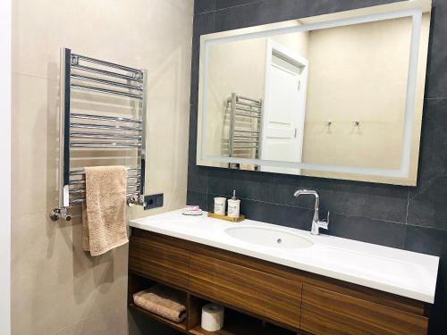 a bathroom with a sink and a mirror at Heart of Yerevan - City Center Luxury Apartments in Yerevan