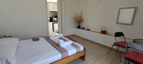 a bedroom with a bed with two towels on it at Platia Studios in Matala