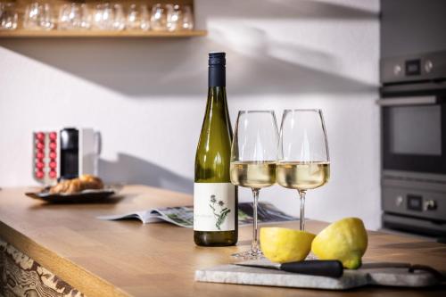 a bottle of wine and two glasses on a counter at residenz5360 in St. Wolfgang