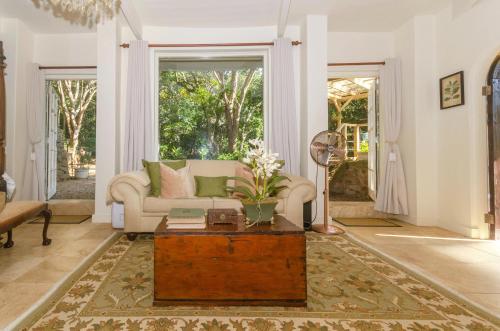 a living room with a couch and a table at MacLeod House Guest Cottage in Kloof