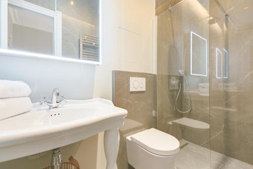 a bathroom with a sink and a toilet and a shower at GuestReady - Lovely flat in Central Paris near Notre-Dame in Paris