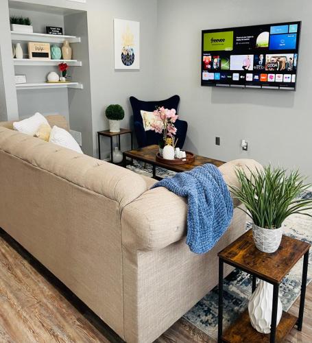 a living room with a couch and a tv at OU-2 bed 2 bath apartment close to OU in Oklahoma City