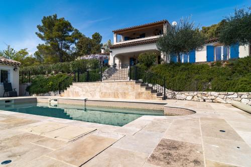 a house with a swimming pool in front of a house at Villa Thalia in Moissac-Bellevue